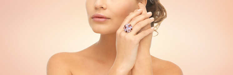 close up of woman with cocktail ring on hand