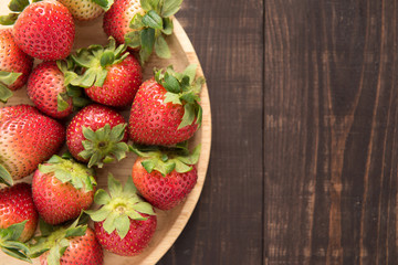 Top view fresh strawberries on old wooden background