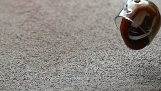 Mug of coffee spilling on carpet in slow motion