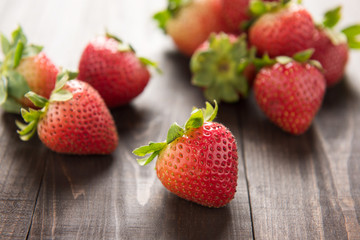 Fresh red strawberries on old wooden background