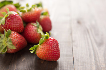 Fresh red strawberries on old wooden background