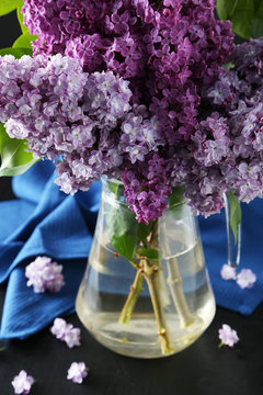 Beautiful lilac in pitcher on black background