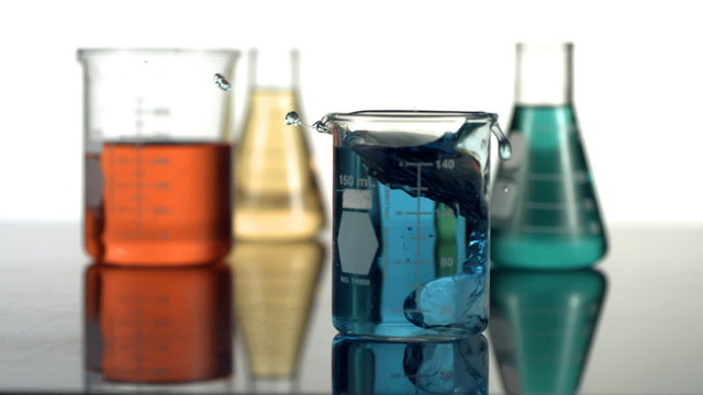 Science beaker splash, slow motion