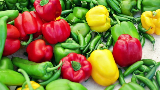 Variety of fresh organic peppers on the table at the local farmer's market.