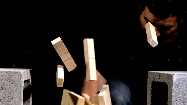 Man breaking boards with hand