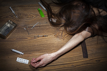 Young woman poses as drug addict.