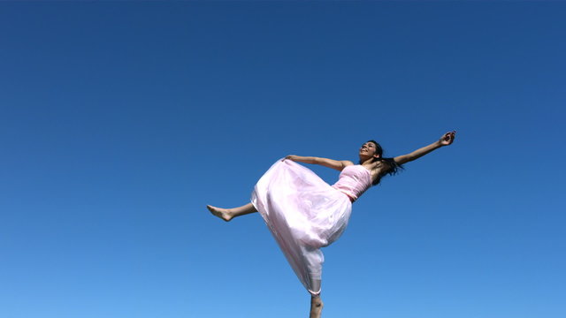Young woman in dress falls, slow motion