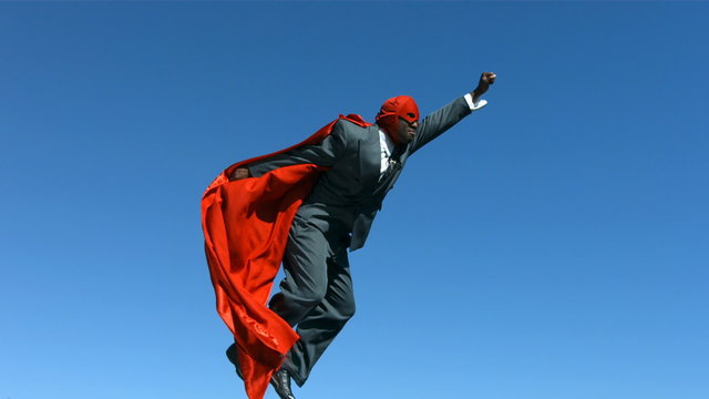 Businessman with superhero mask and cape, slow motion