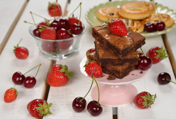 Chocolate brownies with strawberries and cherries