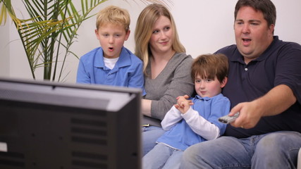 Family watching TV together