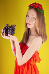 summer girl with bunch of grapes