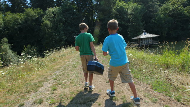 Two boys walking to fishing spot