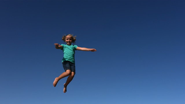 Young girl jumping on trampoline