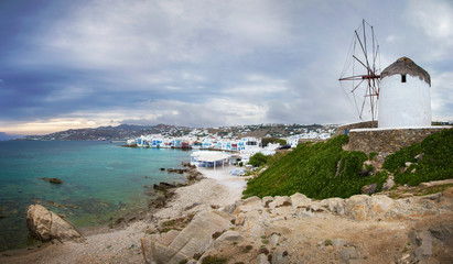 Mykonos town and famous windmill on a cloudy day, Greece