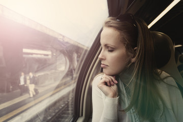 Pensive beautiful woman in a train