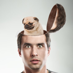 Dog sitting inside the man's opened head