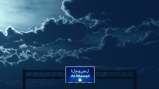 Passing under Al Mawsil Mosul Iraq Highway Road Sign at Night
  