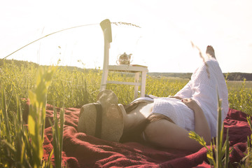 Woman Laying Down on Meadow on Picnic Cloth