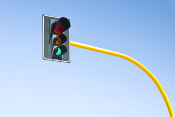 Green trafficlight on blue background 