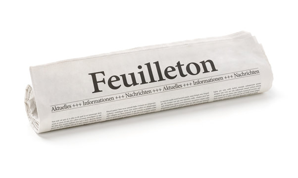 Zeitungsrolle mit der Überschrift Feuilleton