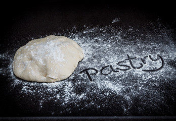 Closeup of pastry dough on baking board