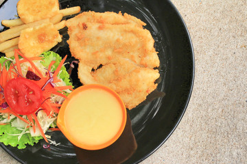 Steaks, french fries with vegetables salad on a plate