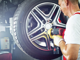 Motor mechanic is changing a tyre