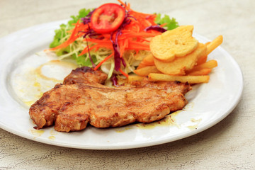 Pork chop, french fries with salad