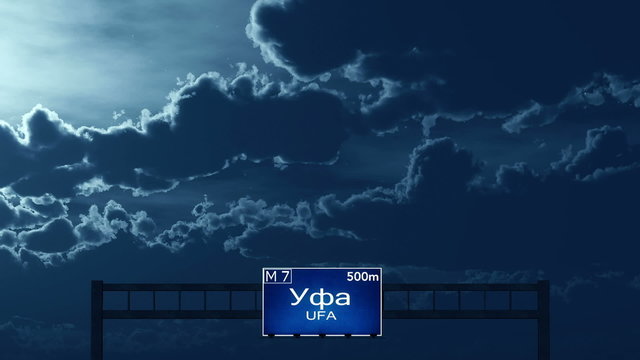 Passing under Ufa Russia Highway Road Sign at Night
  