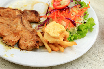 Pork chop, french fries with salad