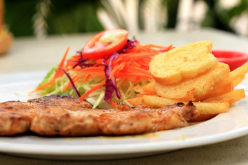 Pork chop, french fries with salad