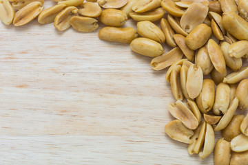 border of  nuts on wood background