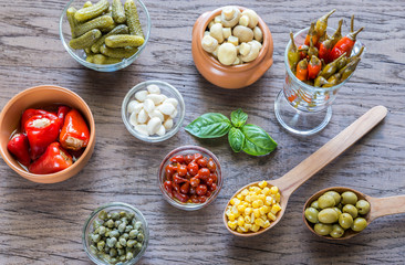 Pickled vegetables on the wooden background