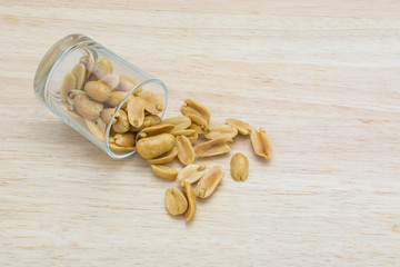 Beans in glass spilled on the wooden background