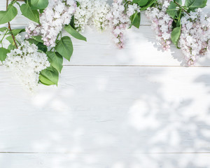 Blooming lilac flowers on the old wooden table.