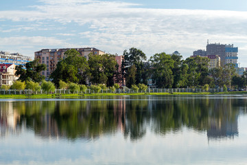Naklejka premium Houses reflected in the water of Lake Nuri. Batumi. Georgia