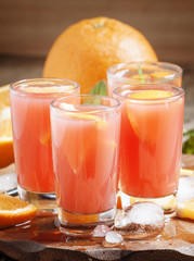 Freshly squeezed juice from red orange, selective focus