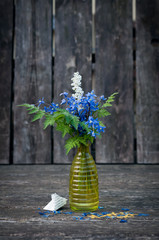 White and blue flowers in the yellow vase