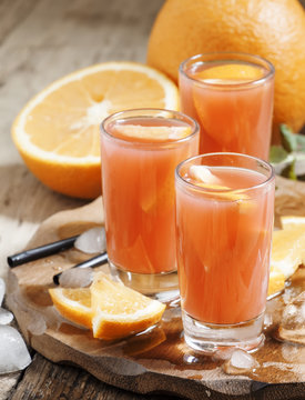 Freshly squeezed juice from red orange, selective focus