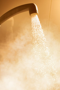 hot shower with flowing water and steam