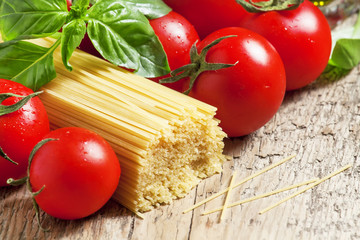 Dry Italian pasta Capellini with tomato and basil, selective foc