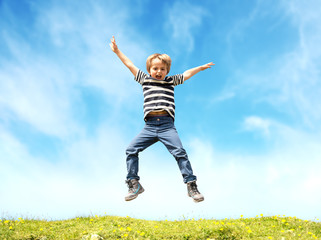 Boy jumping in meadow
