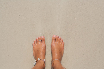 Woman's Bare Feet on the beach.
