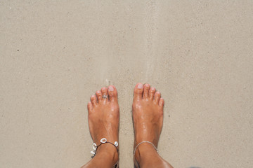 Woman's Bare Feet on the beach.