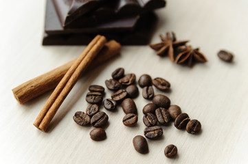 Coffee beans with cinnamon sticks and chocolate