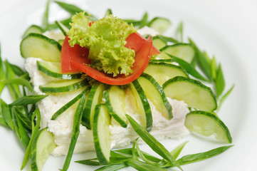 vegetable salad with cucumbers, lettuce, tomatoes and cheese