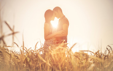 couple kissing in the wheat