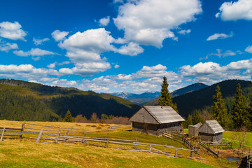 Mountain Landscape with two wooden houses .