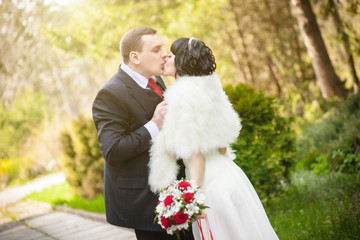 The groom and the bride in a green park