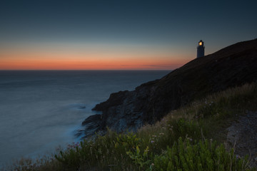 Fototapeta na wymiar Trevose Head lighthouse on rocky cliffs in Cornwall, England